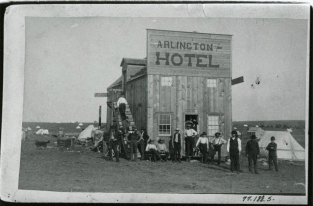 The Arlington Hotel – Guthrie, Oklahoma Territory, 1889. One of the first hotels in the land-run boomtown of Guthrie, Oklahoma Territory. Owned and operated by the fearless Madame Jeffries Star, the Arlington offered hot meals, open doors, and a warm bed to settlers, drifters, and dignitaries alike, serving as both a rest stop and a symbol of frontier resilience.